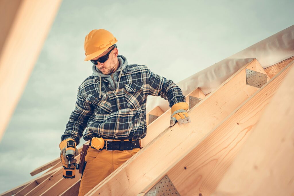 Wooden House Roof Skeleton Frame Assembly by Professional Construction Worker